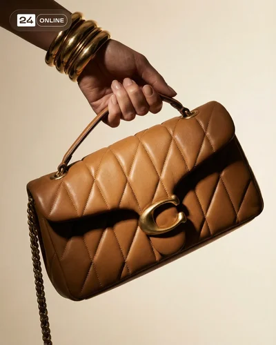 Luxury editorial handbag photography with quilted leather, gold hardware, and warm studio styling.