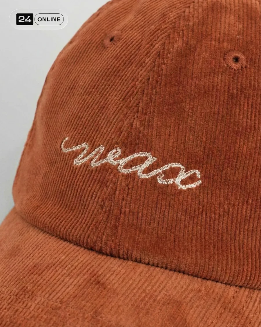 Minimal editorial studio photos of a casual embroidered cap on model and… — AI-generated example 2 of 5