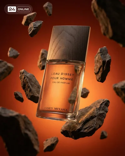 Cinematic luxury fragrance bottle photography with moody lighting, smoke, stone, and warm earthy textures