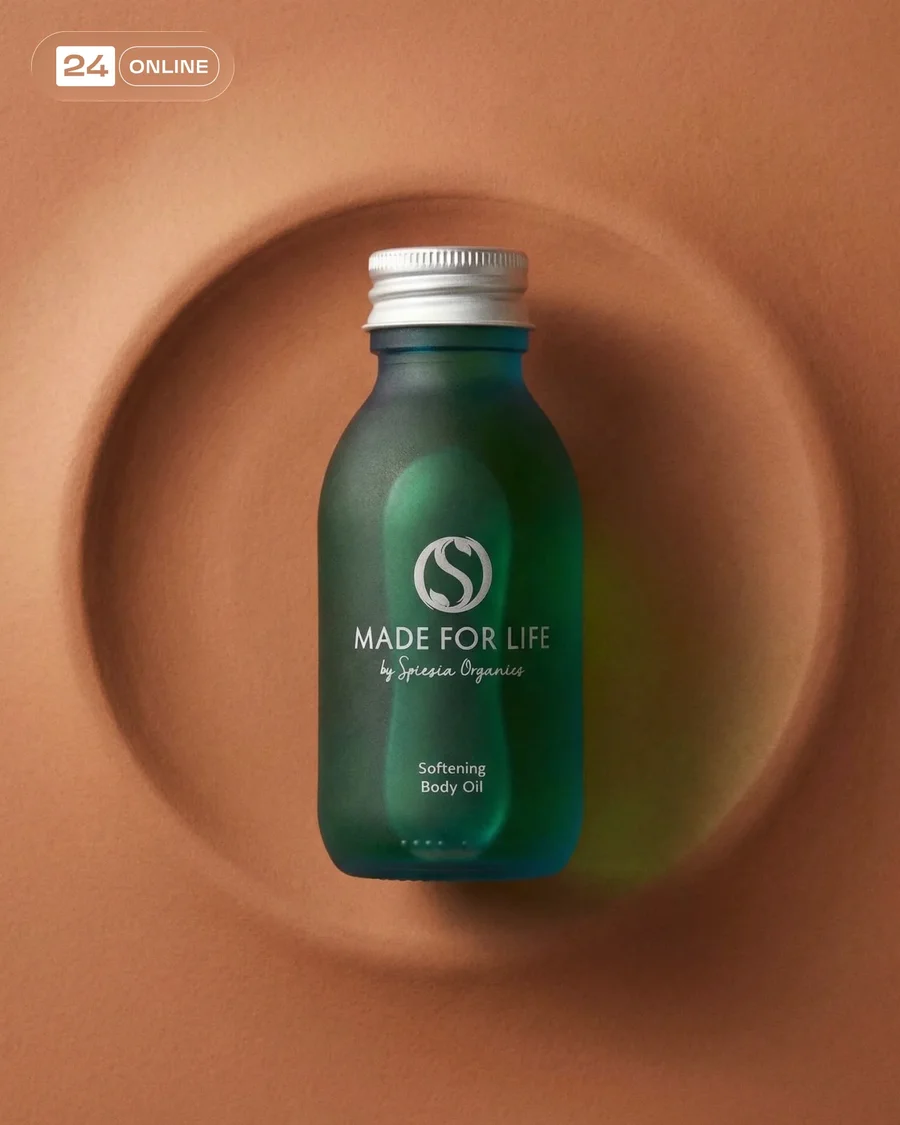 Premium frosted green body oil bottle in editorial skincare studio and natural… — AI-generated example 3 of 4