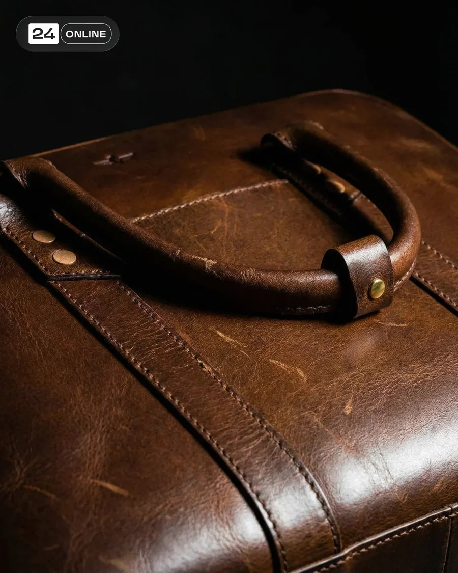 Dramatic studio and macro shots of a rugged leather bag with rich patina — AI-generated example 2 of 2
