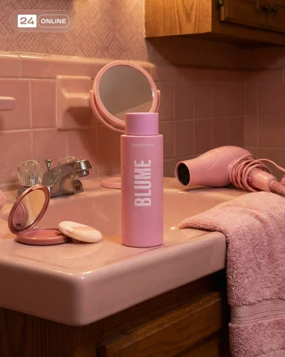 Editorial skincare bottle in nostalgic pink 90s interiors with warm intimate nighttime realism